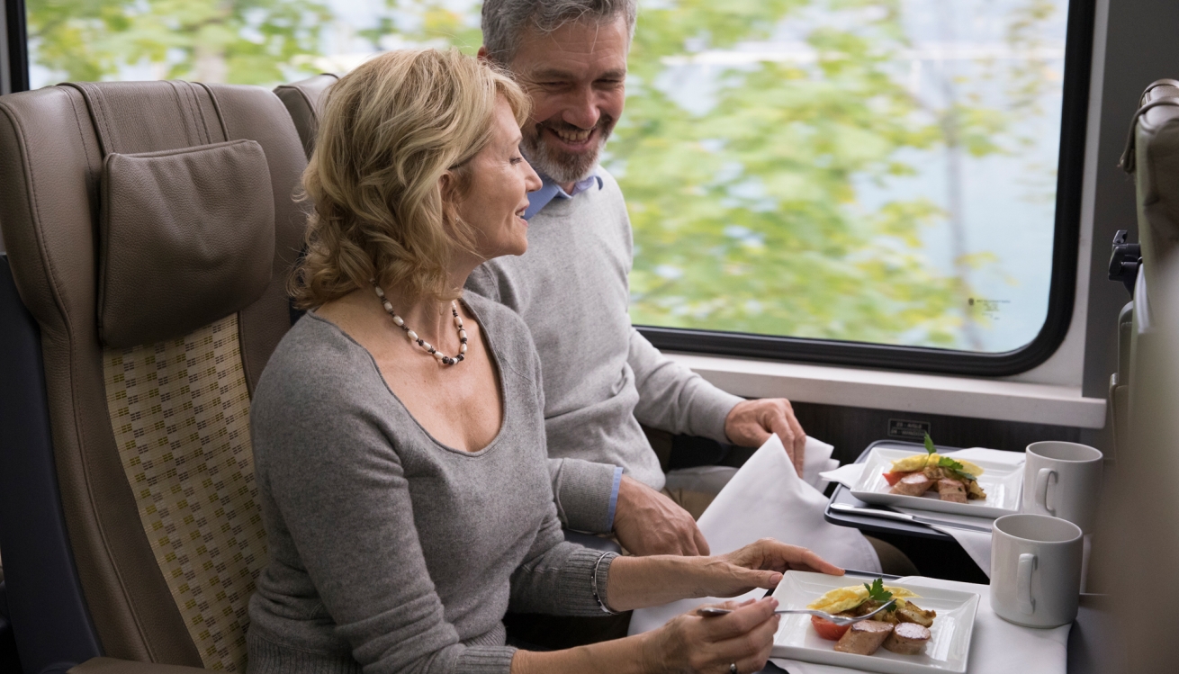 Two guests onboard rocky mountaineer eat breakfast in silverleaf service.