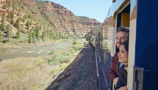 Guests on the SilverLeaf outdoor viewing platform onboard Rocky Mountaineer