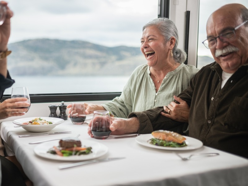 Guests sitting at a dining table with their meals in front of them